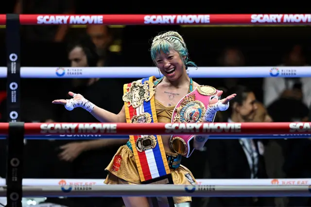 Mizuki Hiruta celebrates with her world title in the ring