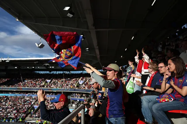 Fan waves a Barca flag in the stadium