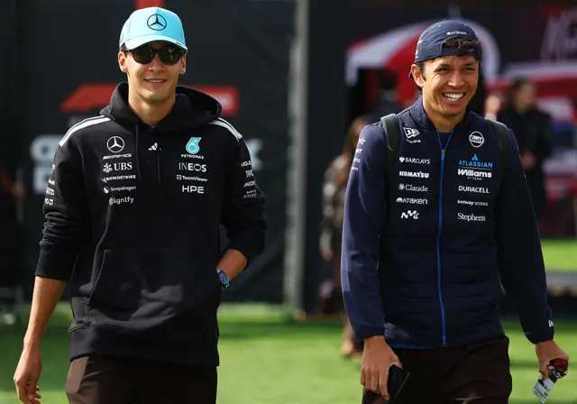 George Russell and Alex Albon enter the paddock in Montreal