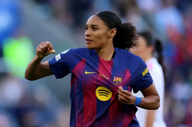 Salma grabs the badge on her shirt after scoring