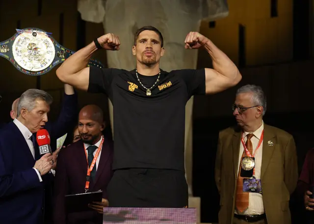 Rico Verhoeven flexing his biceps on the scales
