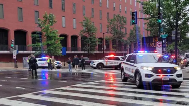 Police vehicles are seen on a blocked street near the White House.