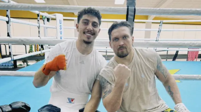 Lewis Williams and Oleksandr Usyk pose for a photo ringside