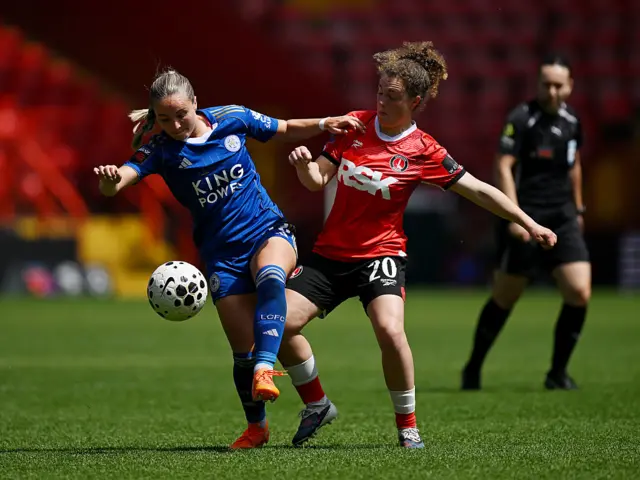 McAteer and McLouglin battle for the ball