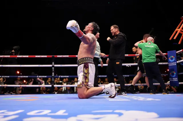 Oleksandr Usyk on his knees celebrating