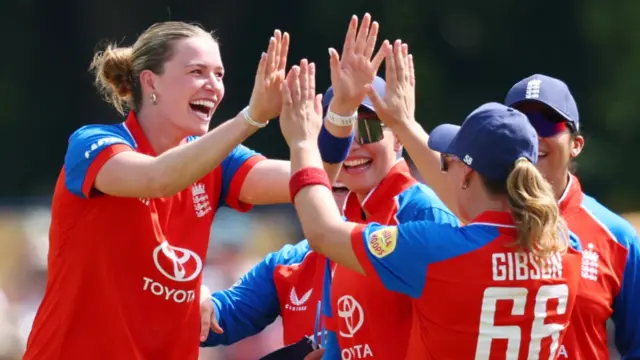 England's Lauren Bell celebrates after taking the wicket of New Zealand's Izzy Gaze with team-mates