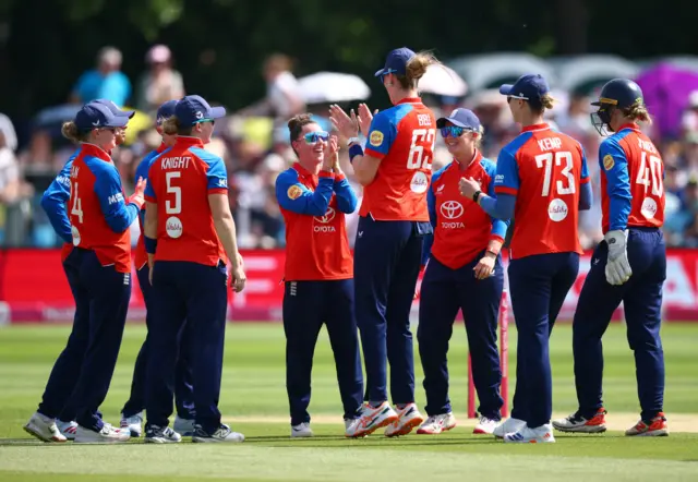 England's Linsey Smith celebrates after taking the wicket of New Zealand's Melie Kerr with team-mates