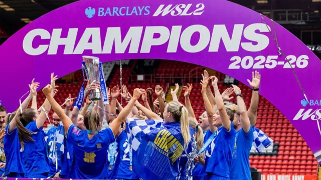 Birmingham City Women's manager Amy Merricks lifts the WSL 2 troph