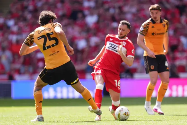 Middlesbrough's Alan Browne (centre) is fouled by Hull City's Matt Crooks (left)