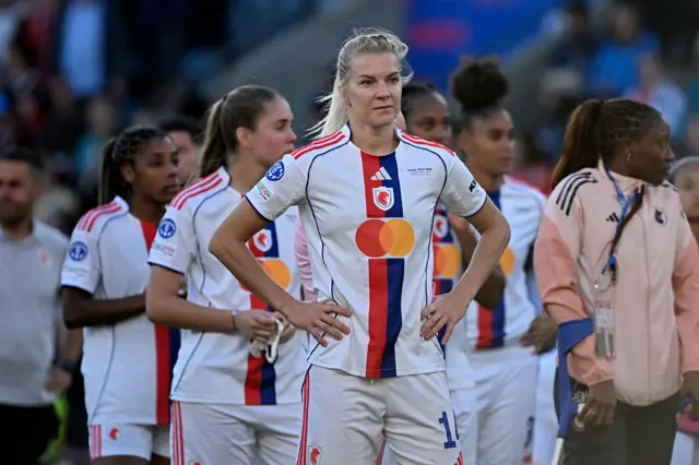 Hegerberg stands with hands on hips