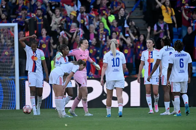 Lyon players hold court after conceding for a second time