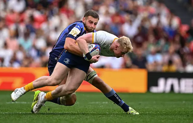 Robbie Henshaw of Leinster is tackled by Pierre Bochaton