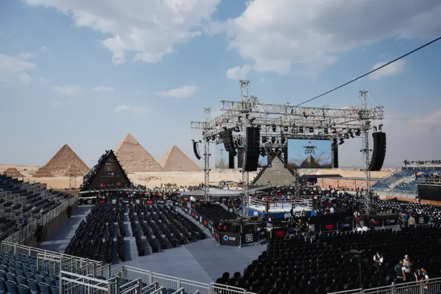 Egyptian pyramids in background of boxing ring