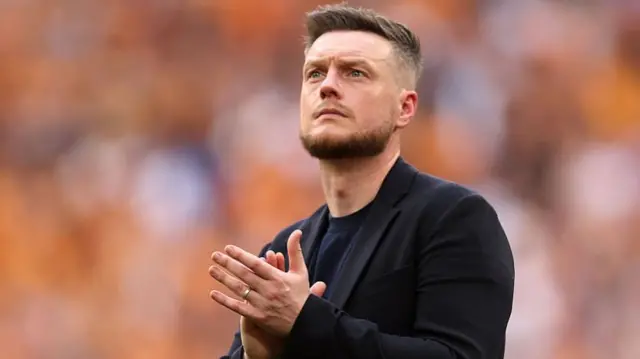 A sad looking Kim Hellberg applauds fans at Wembley