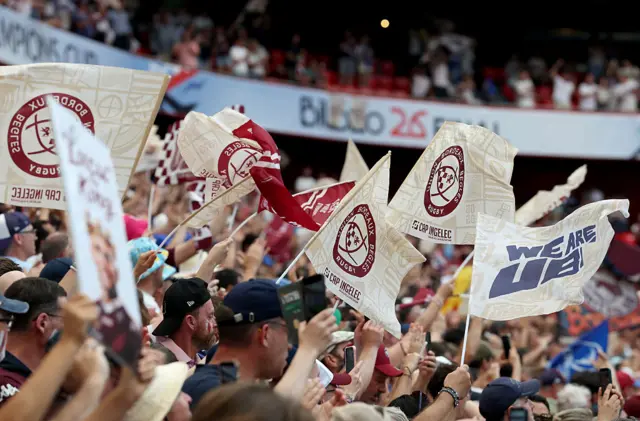 Fans wave flags