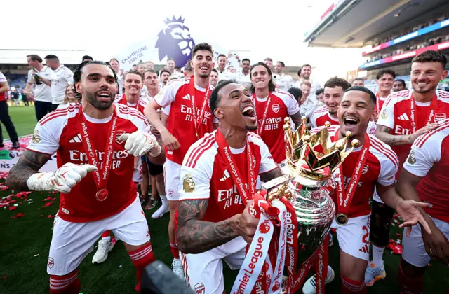 Arsenal players with the Premier League trophy