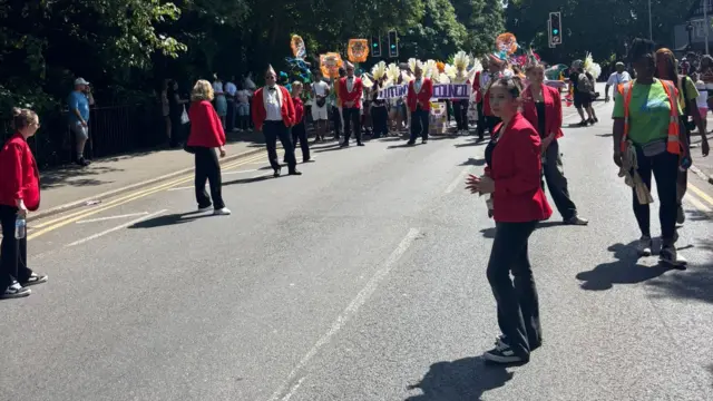 People in red jackets on the carnival route.