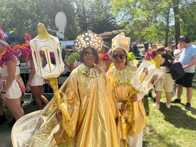 Two women in gold outfits