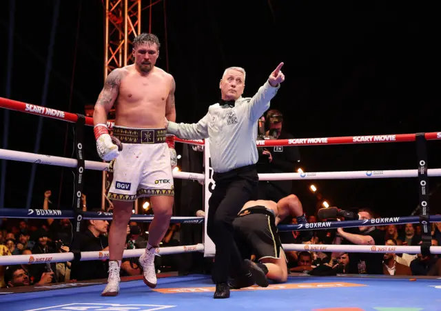 Oleksandr Usyk is pointed away by the referee