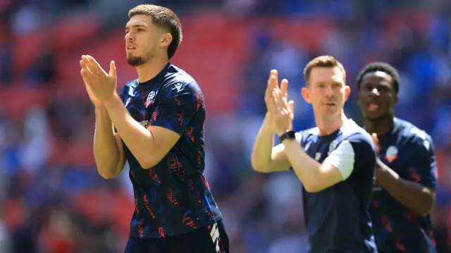 Bolton players clap the fans during the warm-up