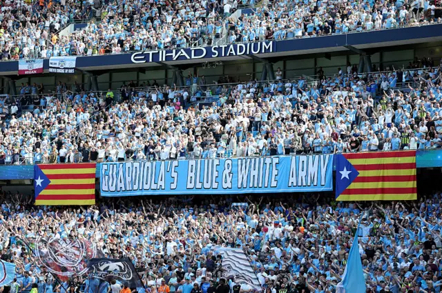 Guardiola's blue and white army banner in the stands
