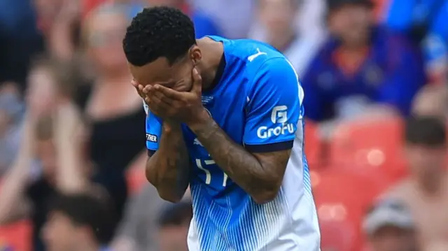 Josh Dacres-Cogley has his head in his hands for Stockport after being sent off
