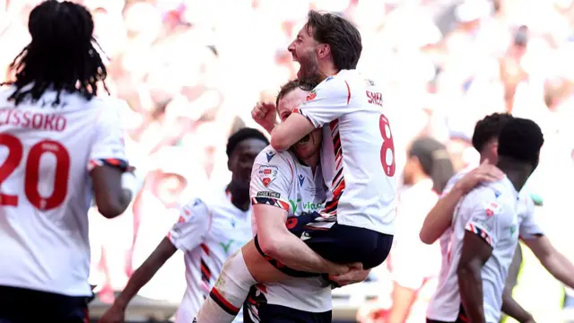 : George Johnston and Josh Sheehan of Bolton Wanderers celebrate after teammate Sam Dalby (not pictured) scored the team's third goal