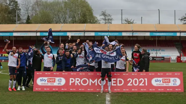 Bolton's players celebrating promotion from League Two in 2021