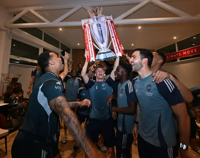 Arsenal with cardboard Premier League trophy