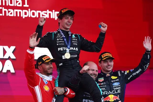 Lewis Hamilton and Max Verstappen lift up Kimi Antonelli