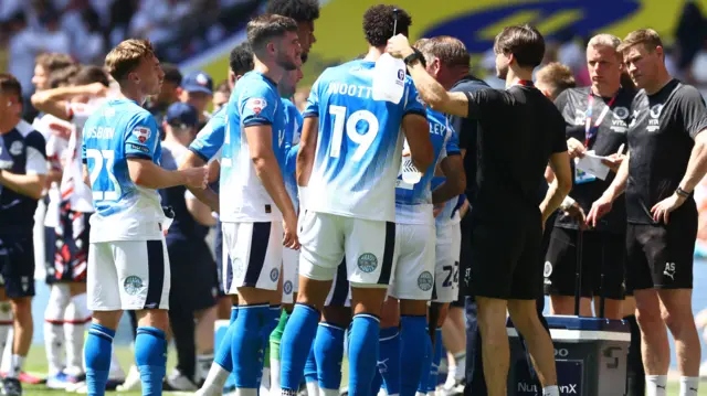 Players cool down at Wembley with water bottles