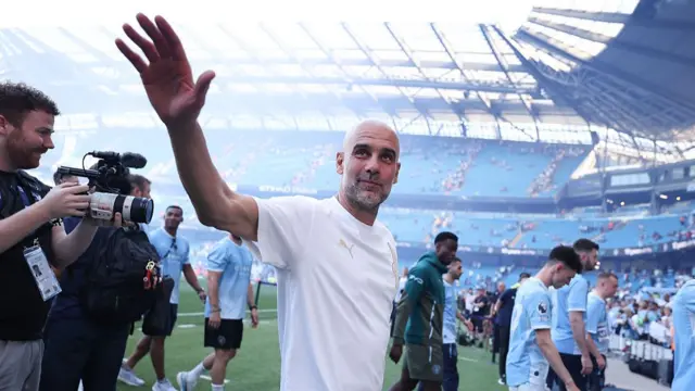 Pep Guardiola waves to the fans