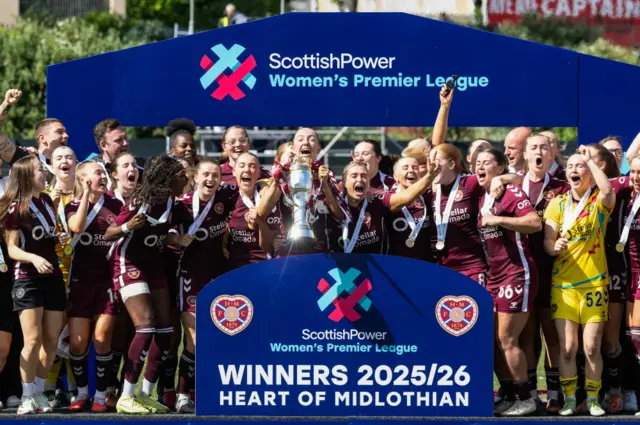 Hearts players lift the SWPL Trophy