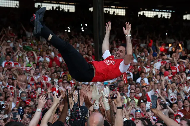 Mikel Artetta being thrown in the air