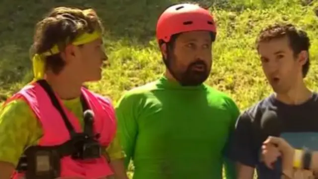 Three men are standing shoulder to shoulder to eachother.
