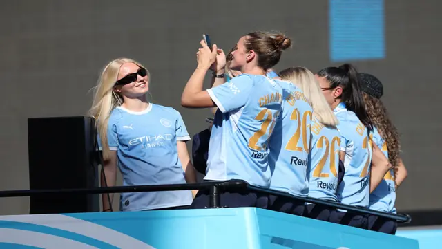 Manchester City women's team on the top of an open top bus in the 2026 trophy parade