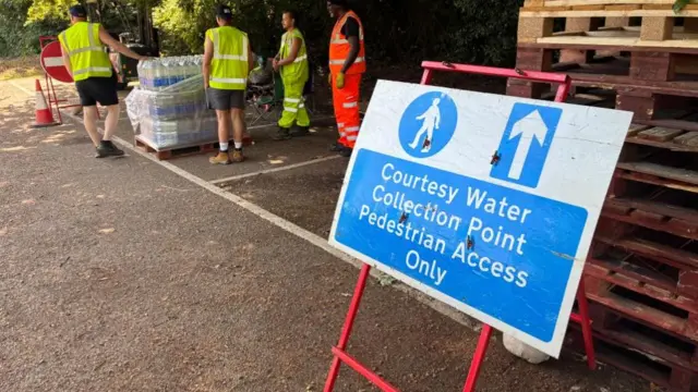 A sign reading Courtesy Water Collection Point Pedestrian Access Only