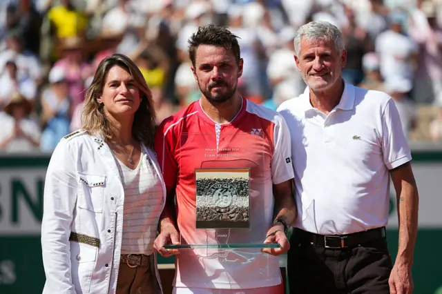 Stan Wawrinka is presented with a commemorative trophy at the French Open