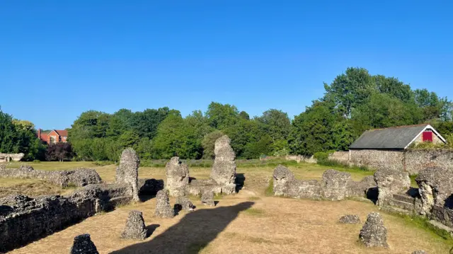 The ruins of an abbey photographed in bright sunshine