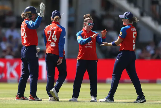 Linsey Smith and England celebrate the wicket of Nensi Patel
