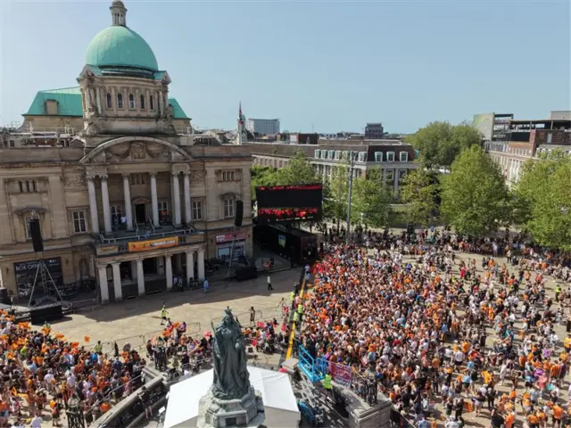 A drone aerial shot of the crowds gathering in Queen Victoria Square, outside the City Hall. The statue of Queen Victoria can be seen at the bottom of the photo.