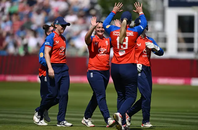 Dani Gibson celebrates the wicket of Melie Kerr