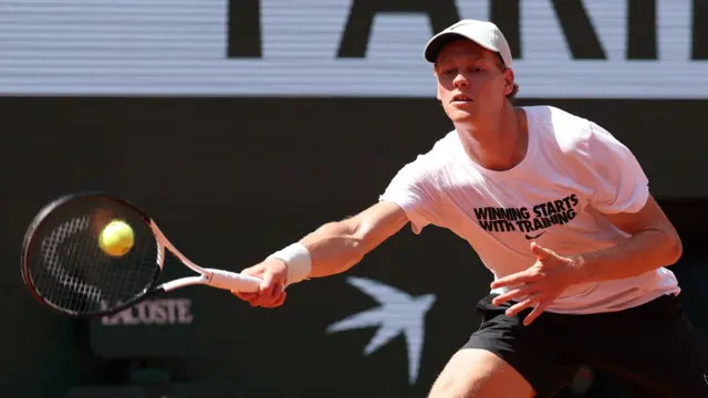 Jannik Sinner hits a forehand during a practice session