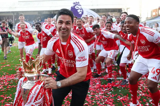 Arsenal manager Mikel Arteta celebrates with the Premier League trophy