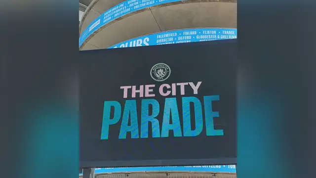 A big screen at the Etihad Stadium where the start of the parade will be screened