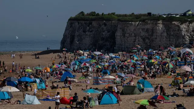 People gather at the beach at Joss Bay as temperatures climb over the bank holiday weekend due to a heat dome spreading across the region, in Broadstairs, Britain, May 24, 2026.