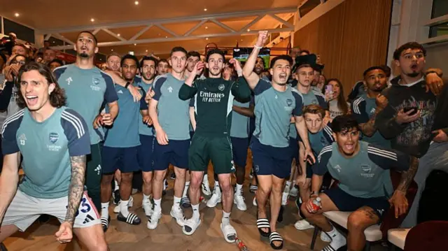 The Arsenal team stood in a line. Some look happy, others terrified