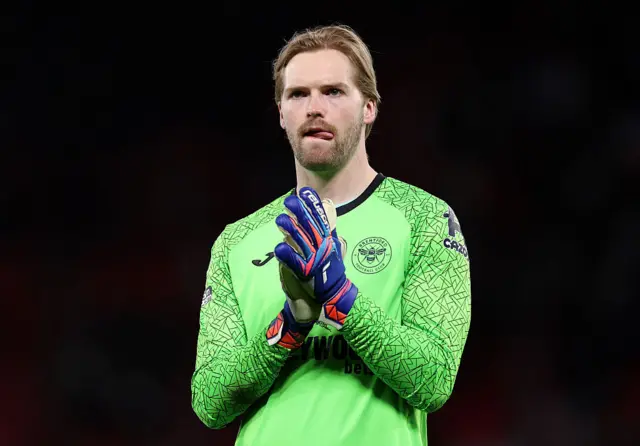 Caoimhin Kelleher of Brentford acknowledges the fans following the Premier League match between Manchester United and Brentford at Old Trafford.