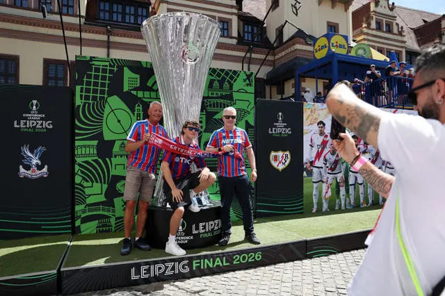 Crystal Palace fans having picture with giant Conference League trophy