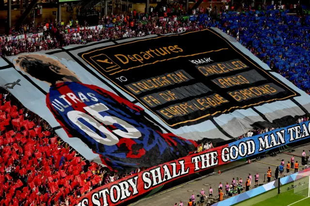 Palace tifo in the stands depicting a departures board of recent milestones